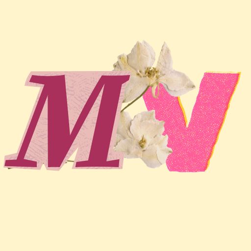 The letters M and V are cutout with a pressed flower behind it. 